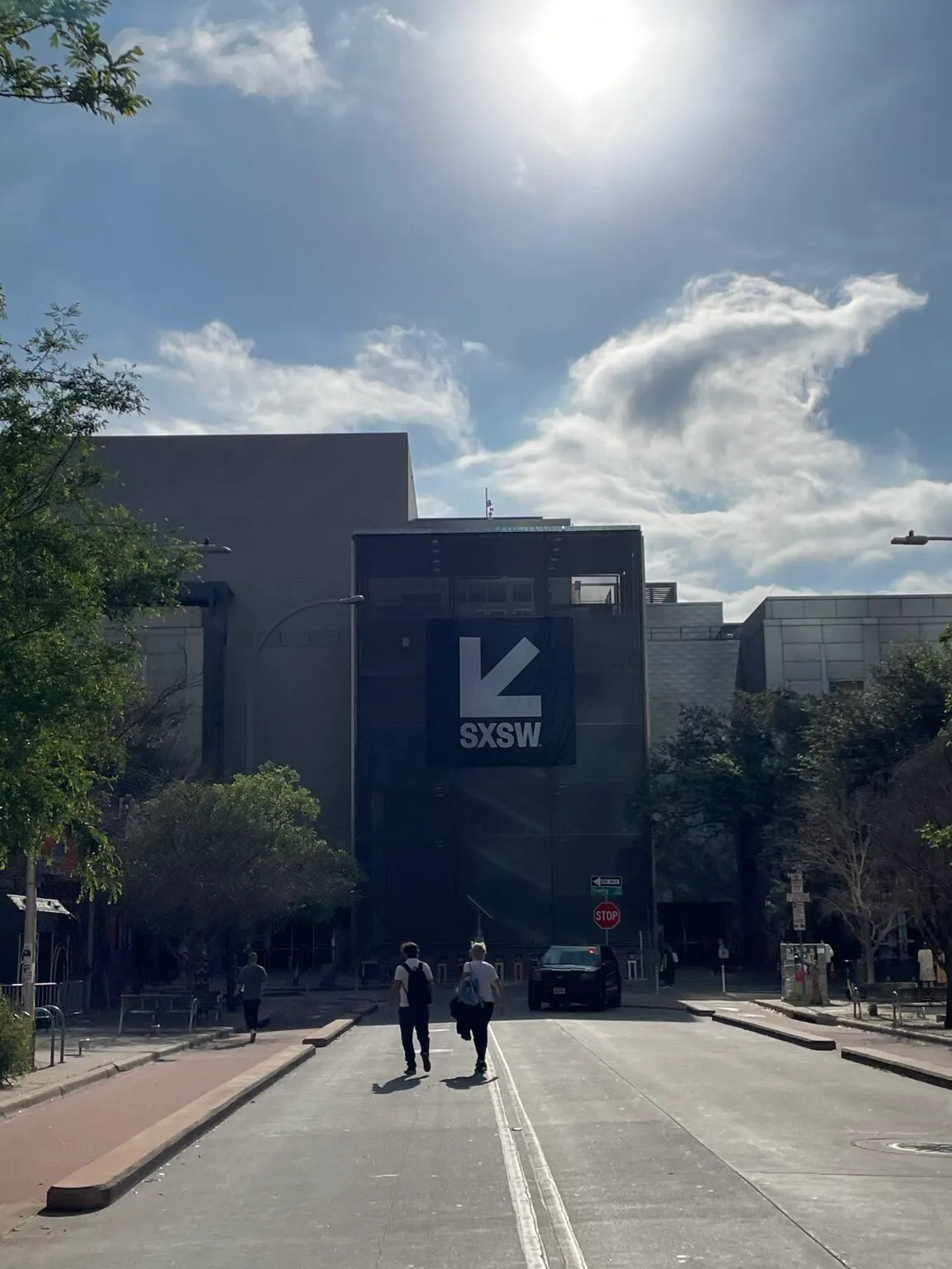 A street approaching a building with an SXSW banner