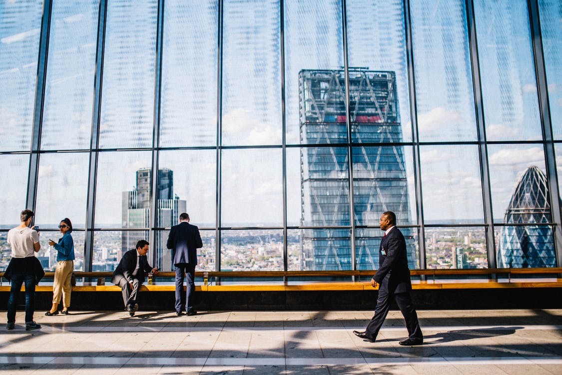 People in a London office building overlooking the city.